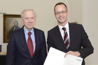 Neuer Honorarprofessor: PD Dr.-Ing. Bert Bosseler (IKT) erhält die Ernennungsurkunde zum Honorarprofessor aus den Händen des Universitäts-Präsidenten, Prof. Dr. Erich Barke (links)